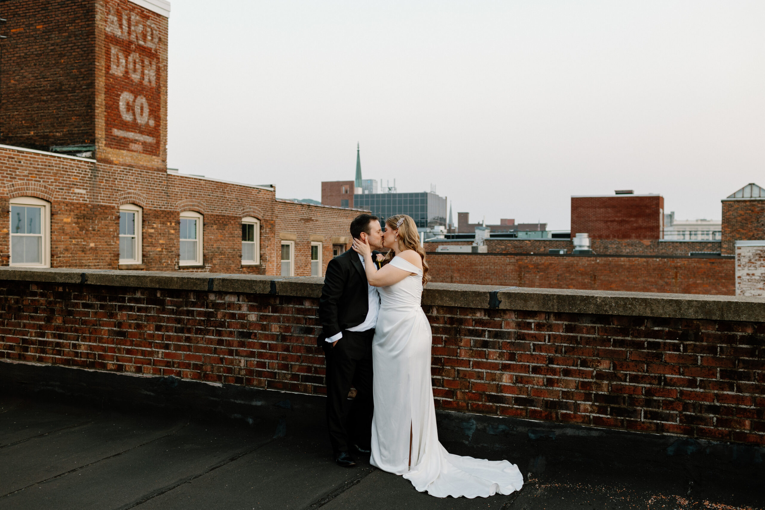 couple kissing on the roof in Troy NY. Albany NY wedding photographer